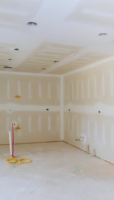 Drywall is hung in kitchen remodeling project Interior of apartment with materials during on the